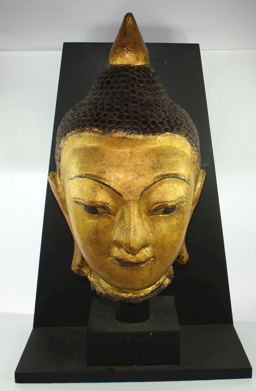 Golden Head of Buddha on Cu... image