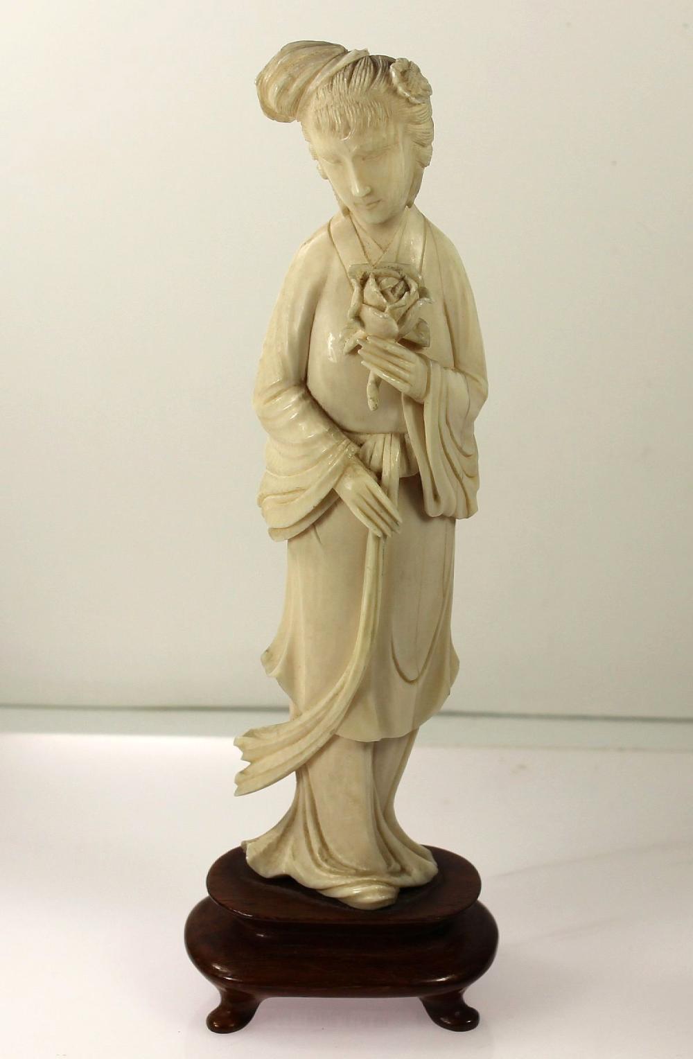 Ivory Statue Of Woman Holdi... image