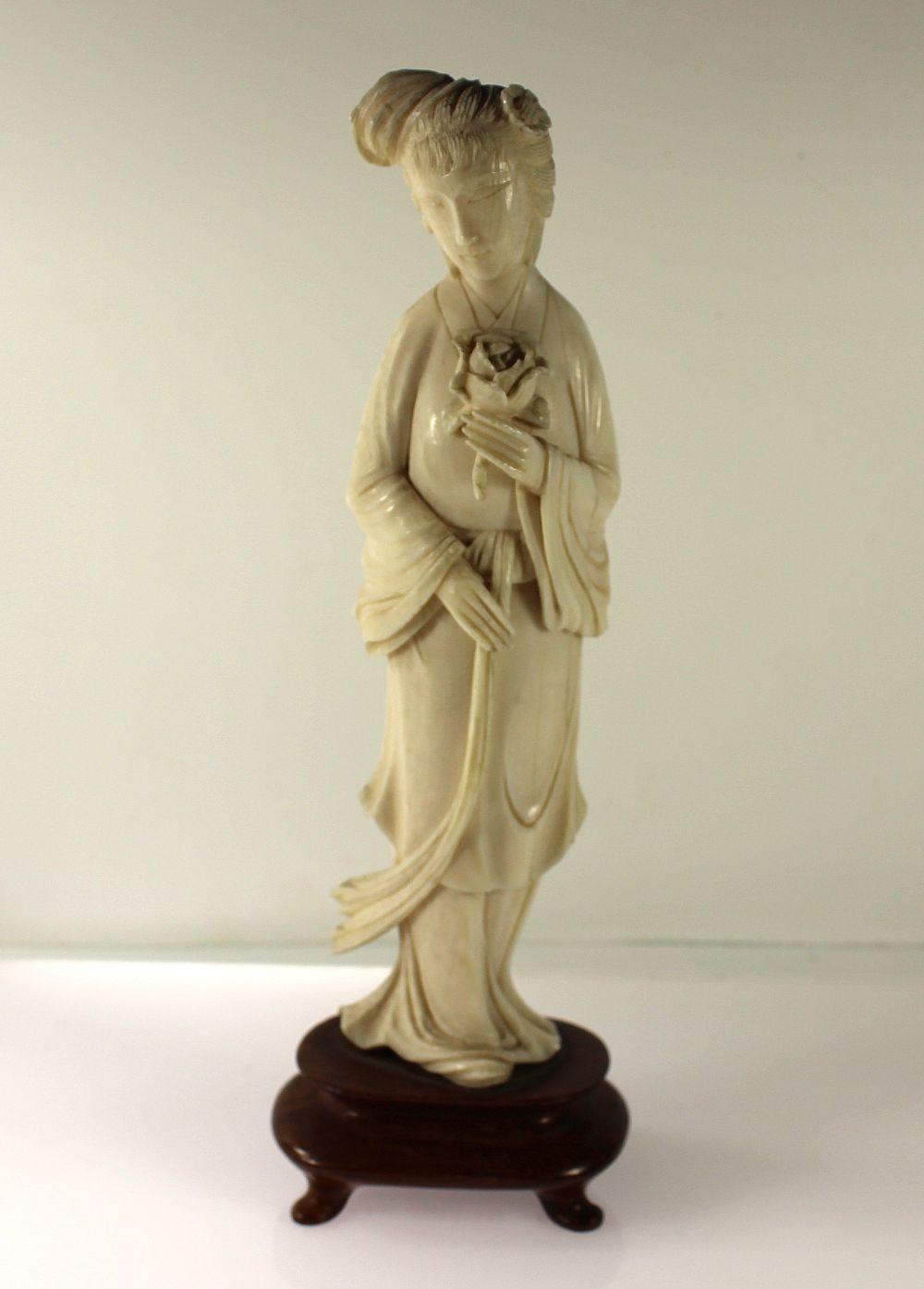 Ivory Statue Of Woman Holdi... image