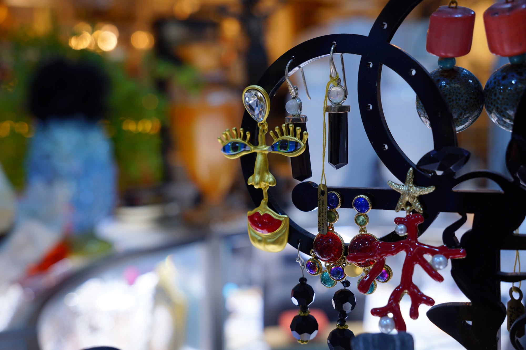 A surrealist gold and enamel earring on display in the rooms
